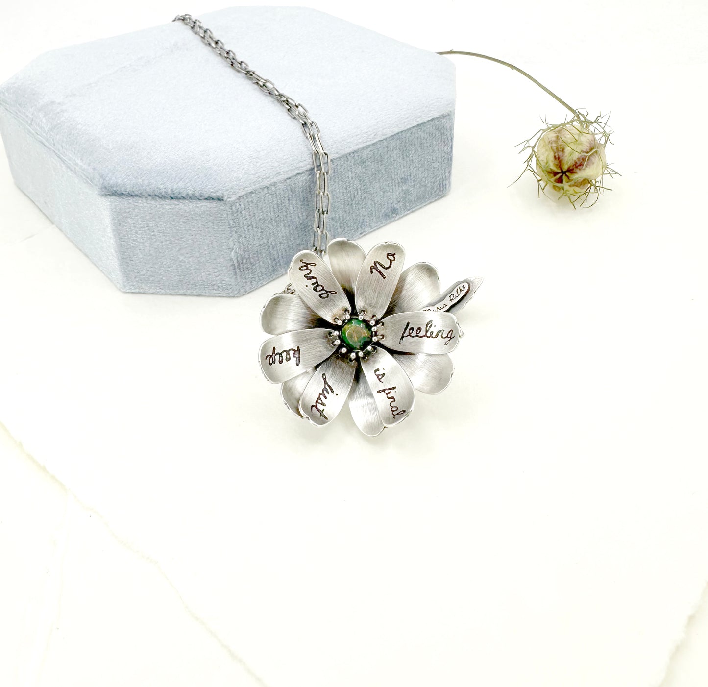 "Let everything happen..." kinetic flower with Rilke quote in sterling silver with black opal.